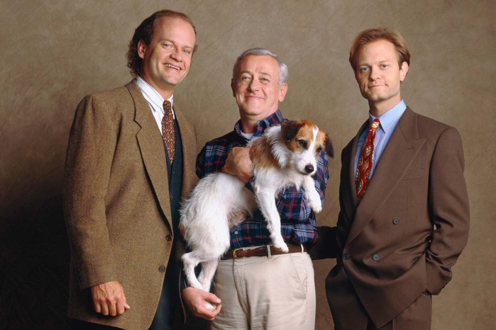 frasier-john-mahoney Kelsey Grammer, John Mahoney and David Hyde Pierce stand side-by-side, smiling, with John also carrying a small dog